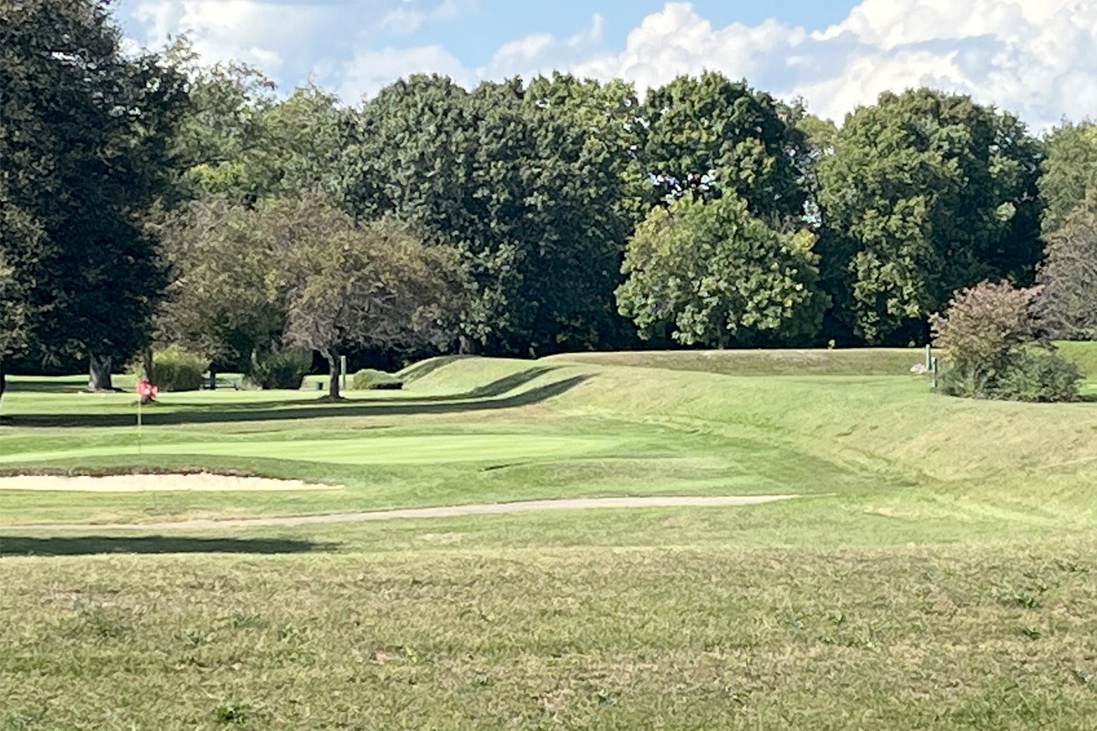 A golf course sand trap lies just inside the earthen wall of the historic site. 